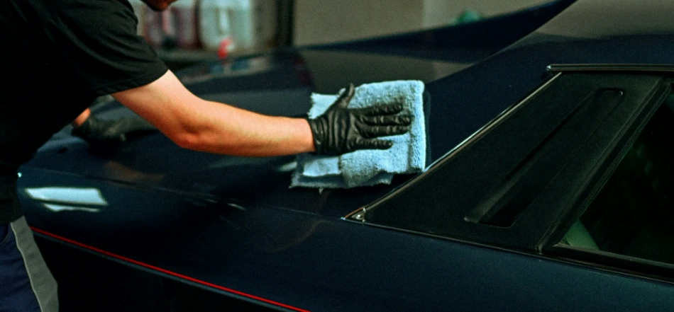 Detailer hand-finishing a freshly ceramic-coated car with a microfiber towel in Bend, Oregon
